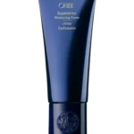 Envase azul vertical de Oribe Supershine Moisturizing Cream de Oribe con tipografía dorada.