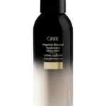 Envase frontal de Oribe Gold Lust Imperial Blowout Transformative Styling Creme de 150 ml sobre fondo blanco