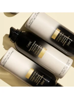 Composición de tres envases de Oribe Gold Lust Imperial Blowout sin tapón para uso profesional en styling