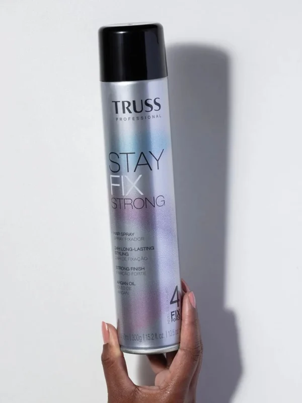 Mano sujetando laca Truss Stay Fix Strong 400 ml producto de fijación fuerte